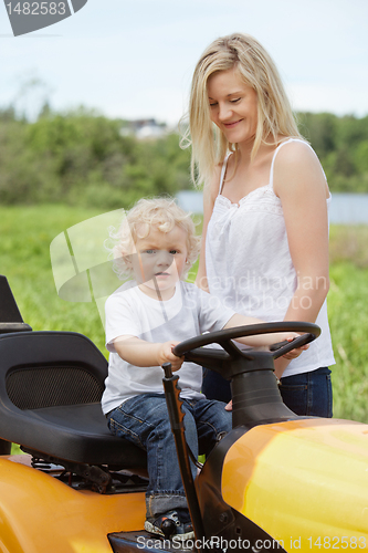 Image of Boy Toddler Sitting on Lawn Tractor