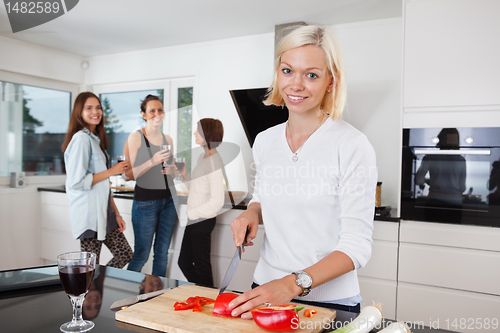 Image of Woman cutting vegetables on counter