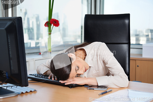 Image of Tired Businesswoman Sleeping in Office