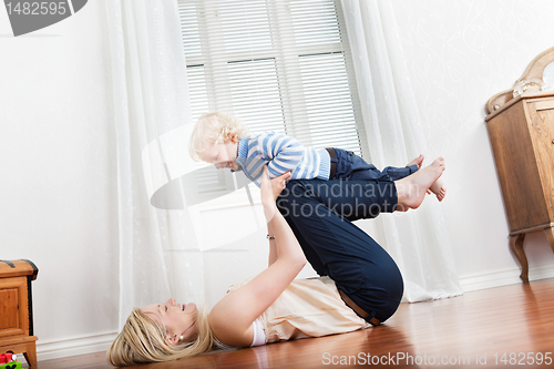 Image of Mother playing with baby boy