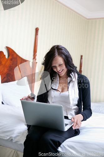 Image of Smiling Businesswoman Using Laptop