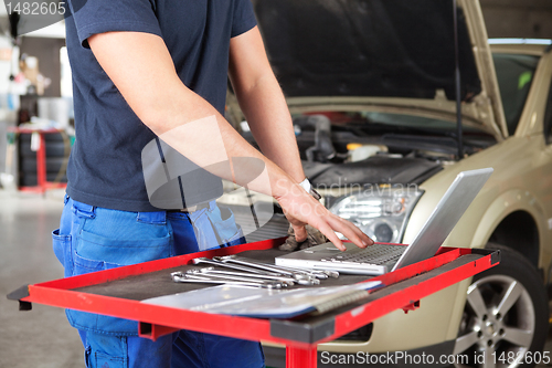 Image of Mechanic working on a laptop