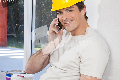 Image of Construction worker on cellphone