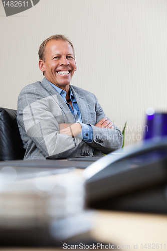 Image of Portrait of executive sitting with hands folded