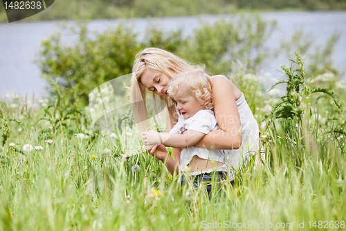 Image of Mother and child in grass