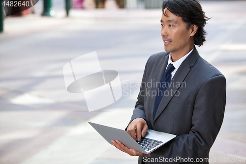 Image of Business Man with Laptop Outdoors
