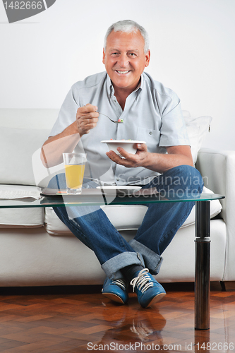 Image of Senior Man Having Breakfast