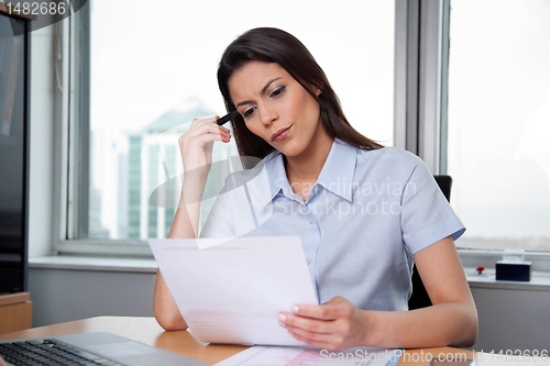 Image of Woman Reading Important Business Papers