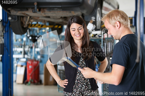 Image of Happy Female Customer at Mechanic