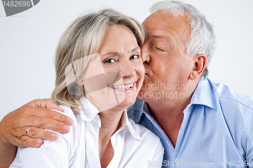 Image of Woman Being Affectionately Kissed By Her Husband