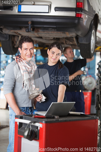 Image of Portrait of garage worker and client