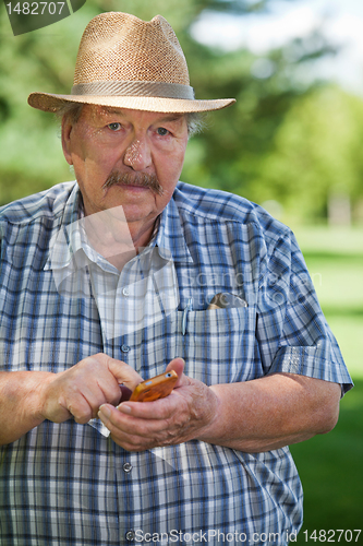 Image of Senior Man Writing Text message