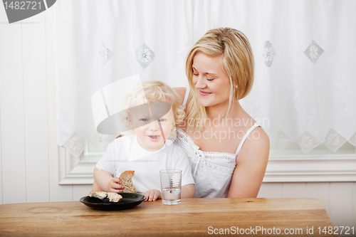 Image of Young woman looking at baby boy