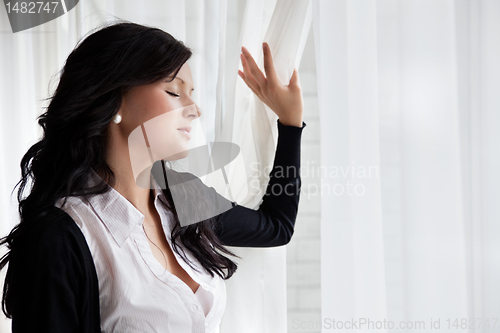 Image of Calm Business woman Standing Near the Window