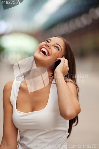 Image of Cheerful Woman Talking on Cell Phone