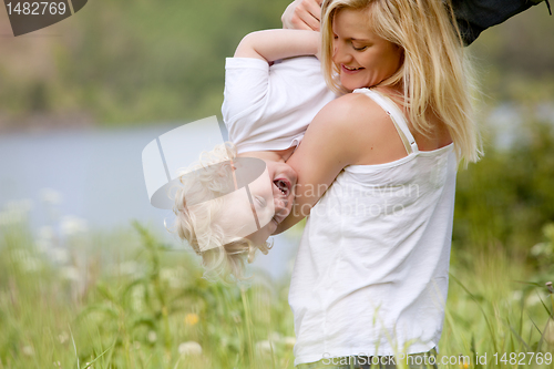 Image of Mother and Son Playing in Meadow