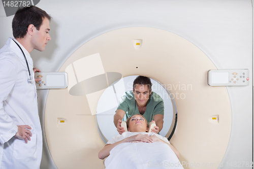 Image of Male nurse preparing patient for CT test