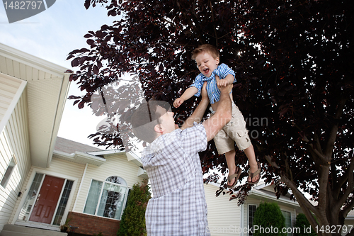 Image of Father Lifting Son in Air