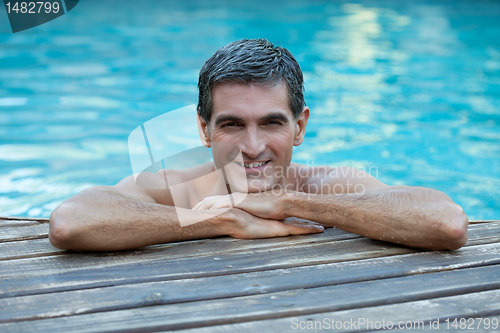 Image of Man Relaxing by Pool's Edge