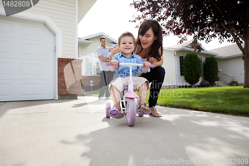 Image of Mother Teaching Son To Ride Bike