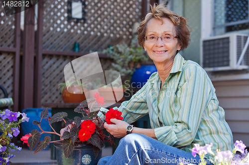 Image of Senior woman with potted plant