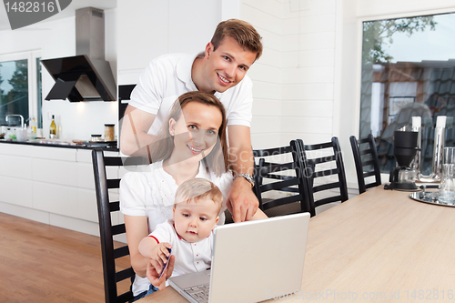 Image of Happy family with laptop