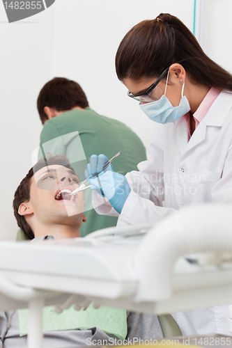 Image of Dentist working on patient's teeth