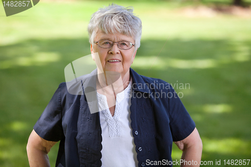 Image of Senior woman standing in park