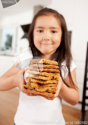 Image of Young Girl Holding Stack of Cookies