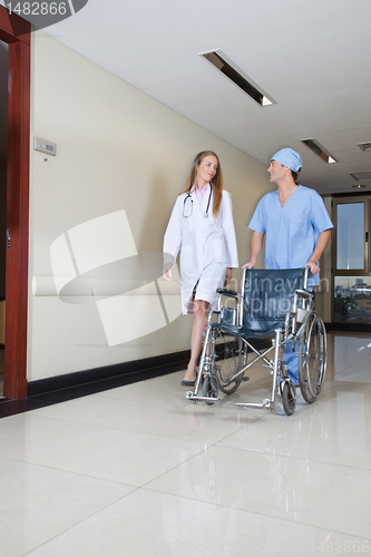 Image of Doctor walking with male nurse