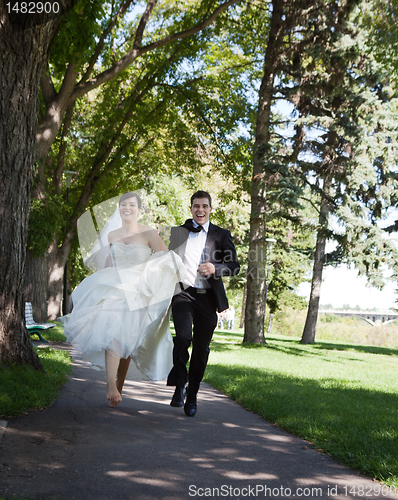 Image of Bride and Groom Running