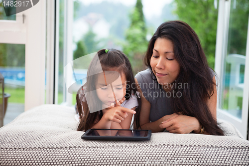 Image of Mother and Daughter with Digital Tablet