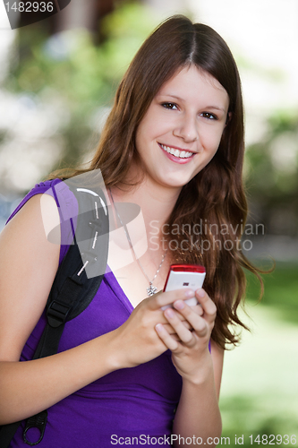 Image of College girl holding cell phone