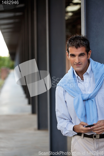 Image of Casual Middle Aged Man Using Cell Phone