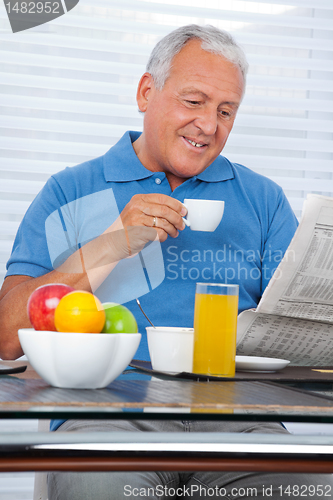 Image of Senior Man Reading Newspaper