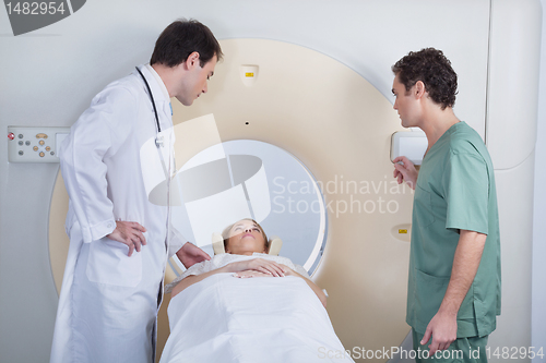 Image of Doctor with technician examining patient