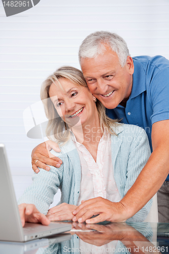 Image of Couple Using Laptop