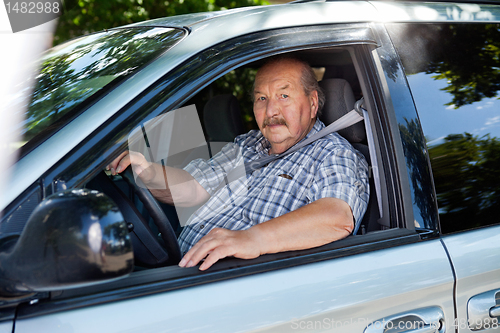 Image of Senior man driving a car