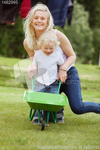 Image of Mother and Son Pushing a Wheelbarrow