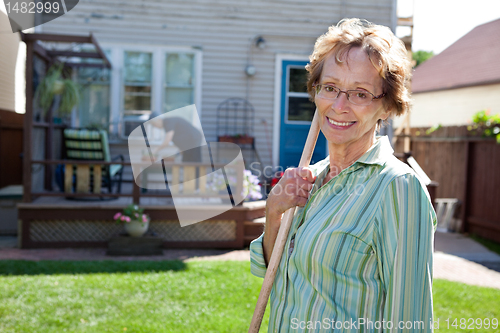 Image of Senior Woman holding gardening tool
