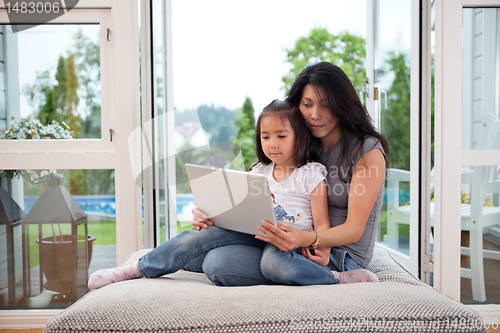 Image of Mother and daughter with laptop