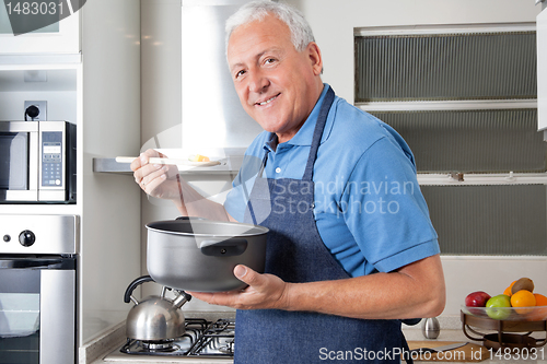 Image of Senior Man Tasting Food