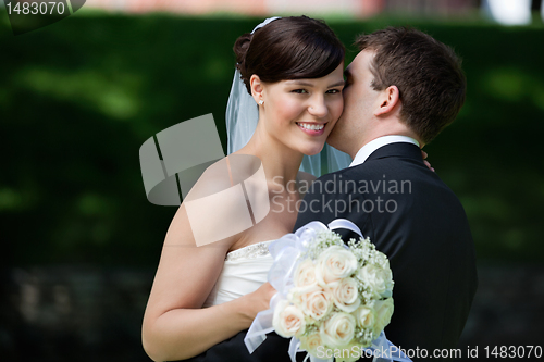 Image of Man Kissing Wife on Cheeks