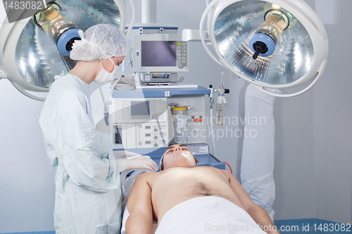 Image of Surgeon checking patient before operation