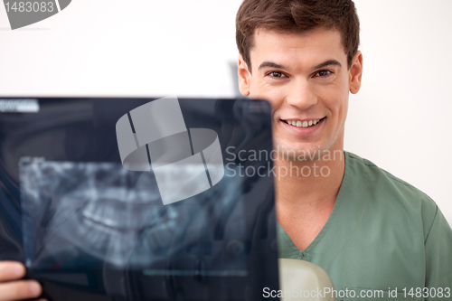 Image of Happy Smiling Man Dentist Holding X-ray