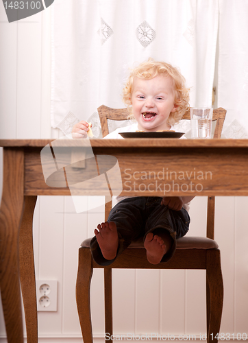 Image of Excited Child at Meal Table