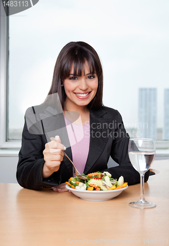 Image of Businesswoman Eating Salad at Workplace