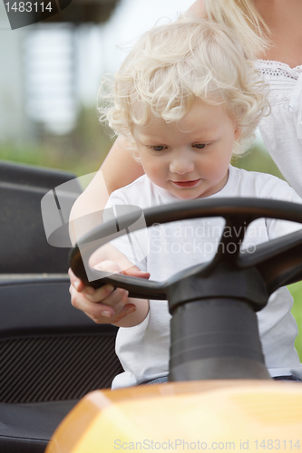 Image of Young Boy Holding Steering Wheel