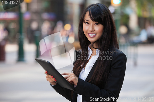 Image of Portrait of businesswoman using tablet pc