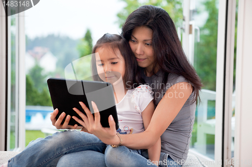 Image of Mother and girl with E-book